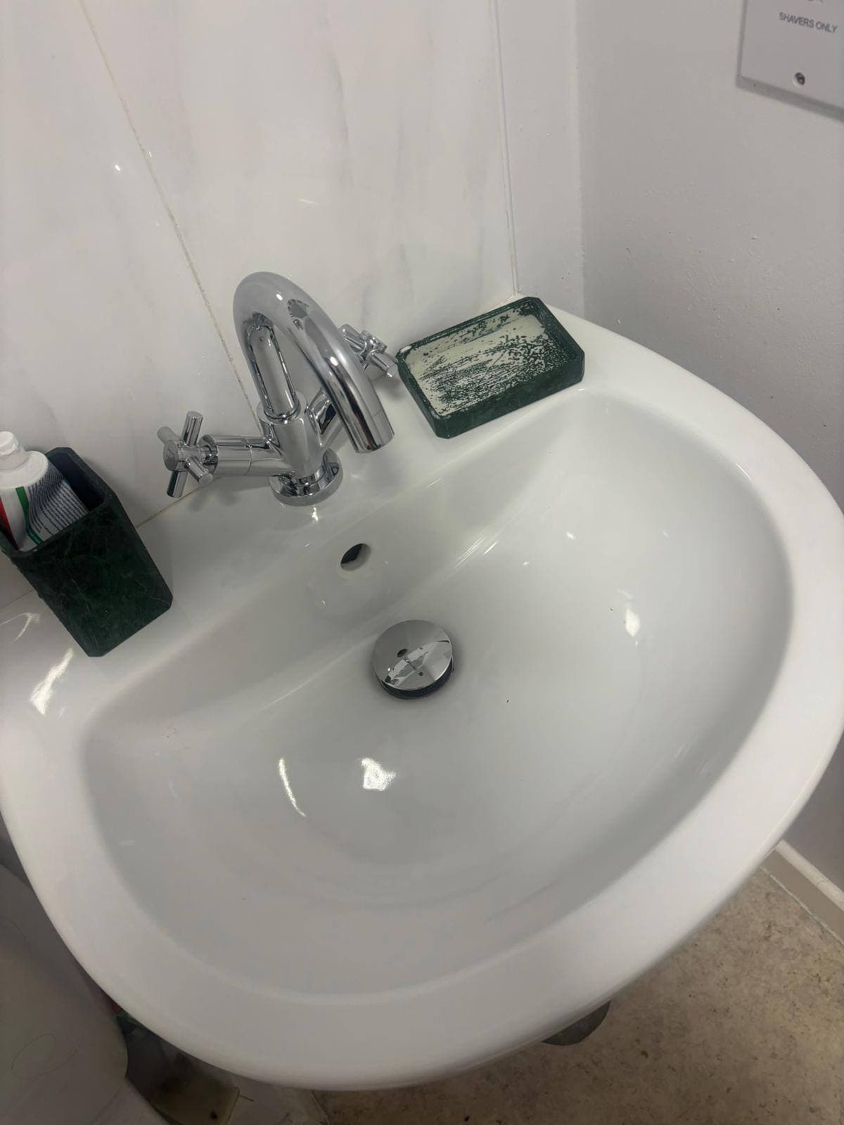 The same bathroom basin scrubbed back to a clean white finish with a polished chrome tap after cleaning