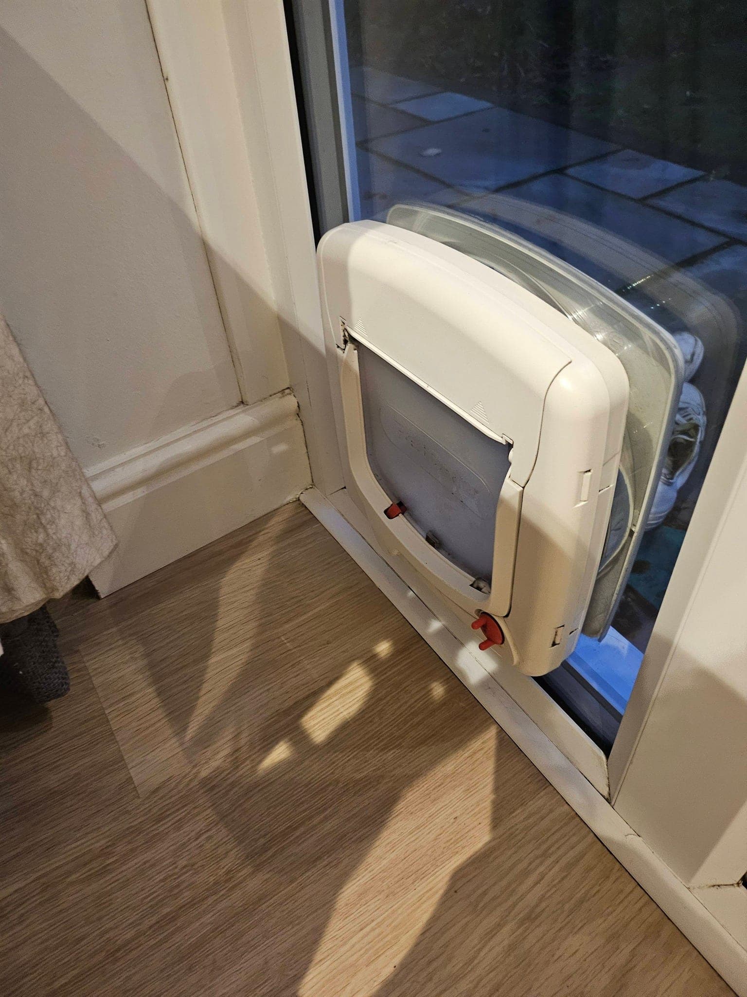 The same cat flap and door frame cleaned to a bright white finish