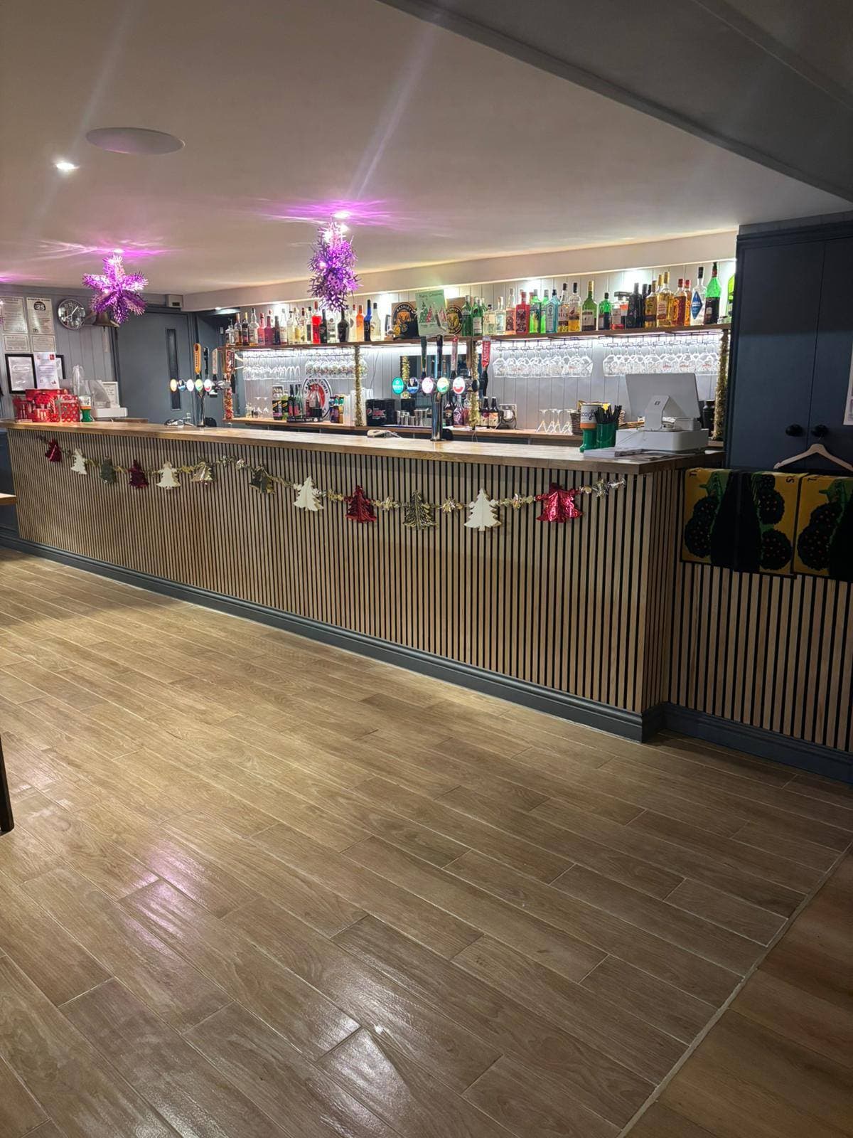 Bar area with clean wood-effect floor and polished back bar after a deep clean