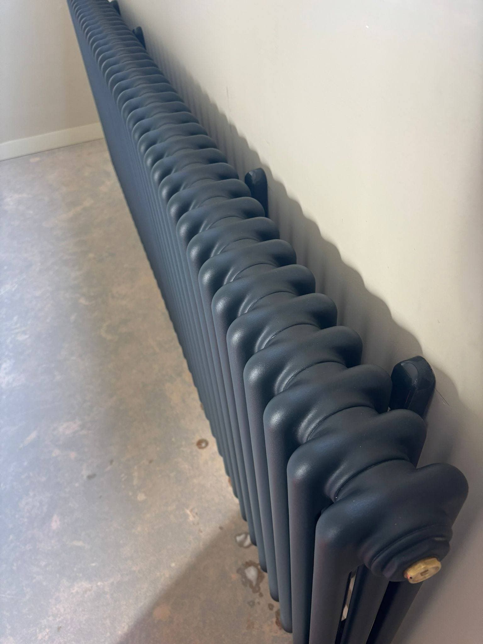 The same column radiator detailed back to a clean matt finish