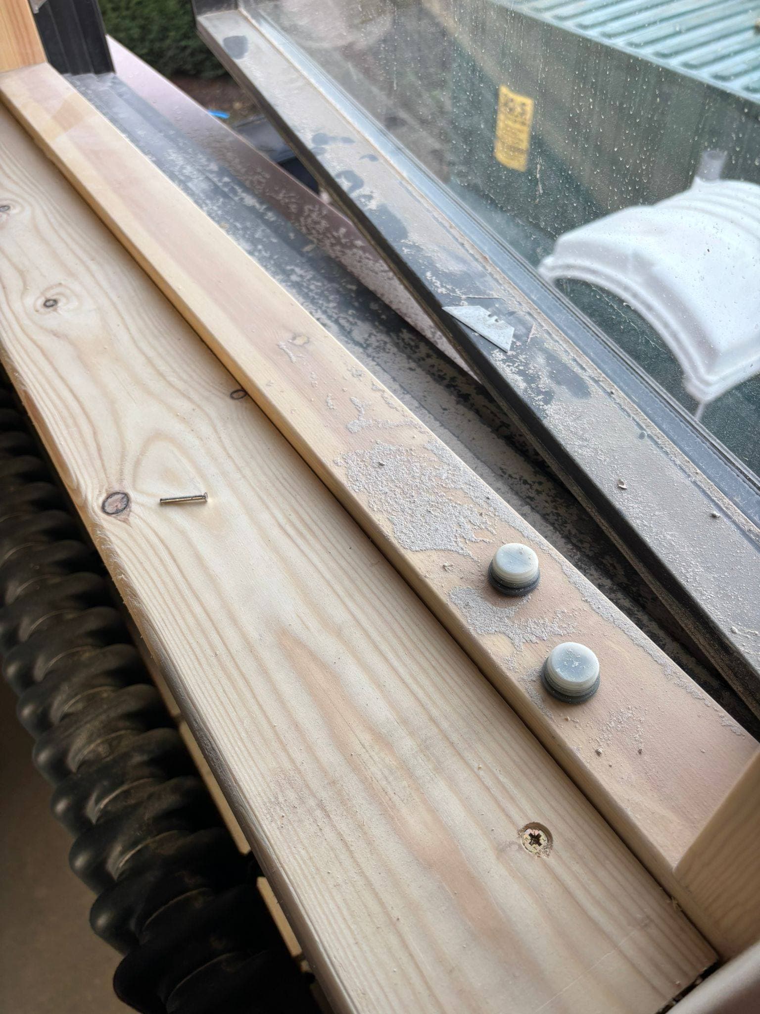 New timber window sill spattered with sealant residue and dust