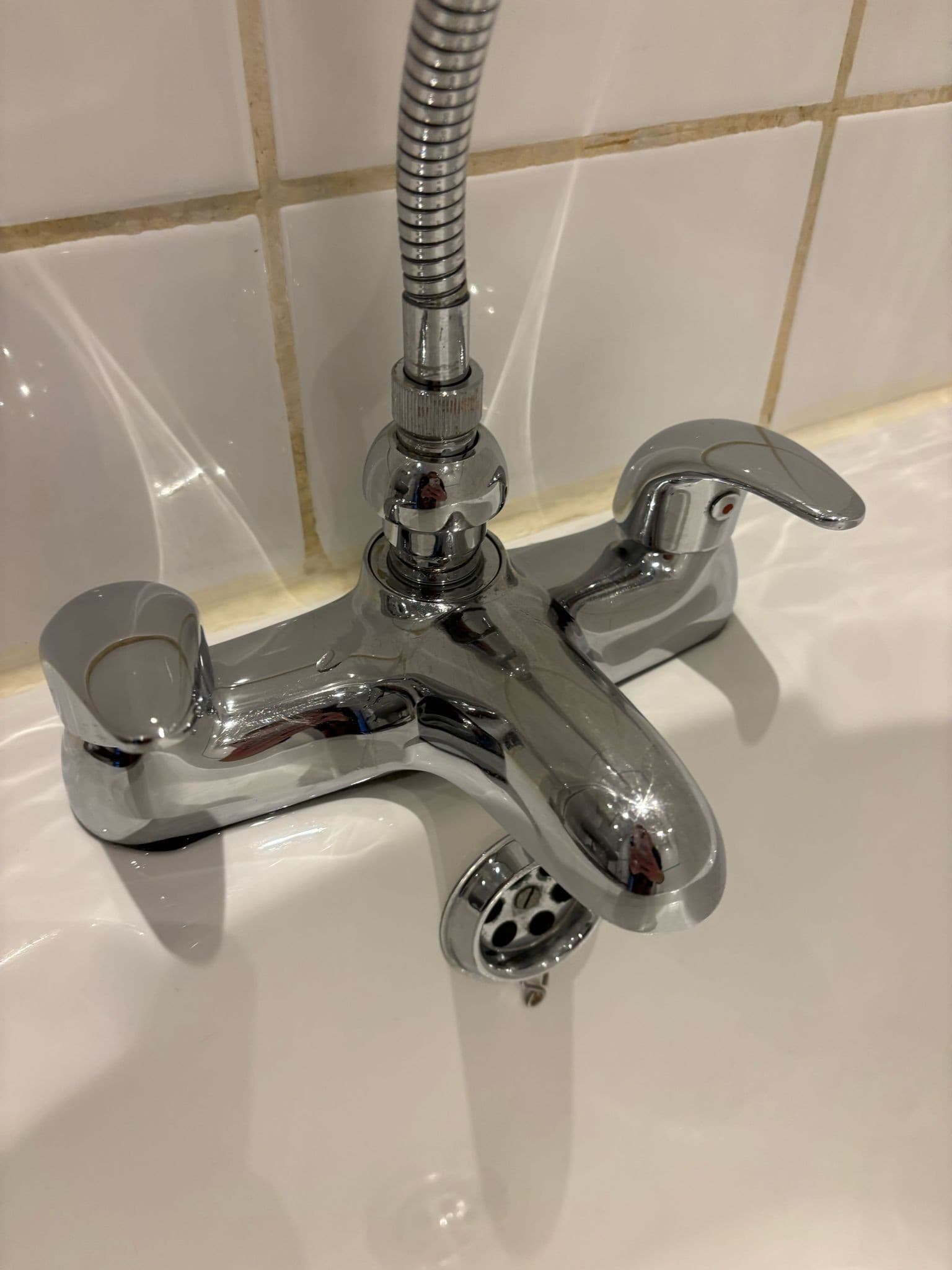 The same bath taps descaled and polished back to a mirror shine