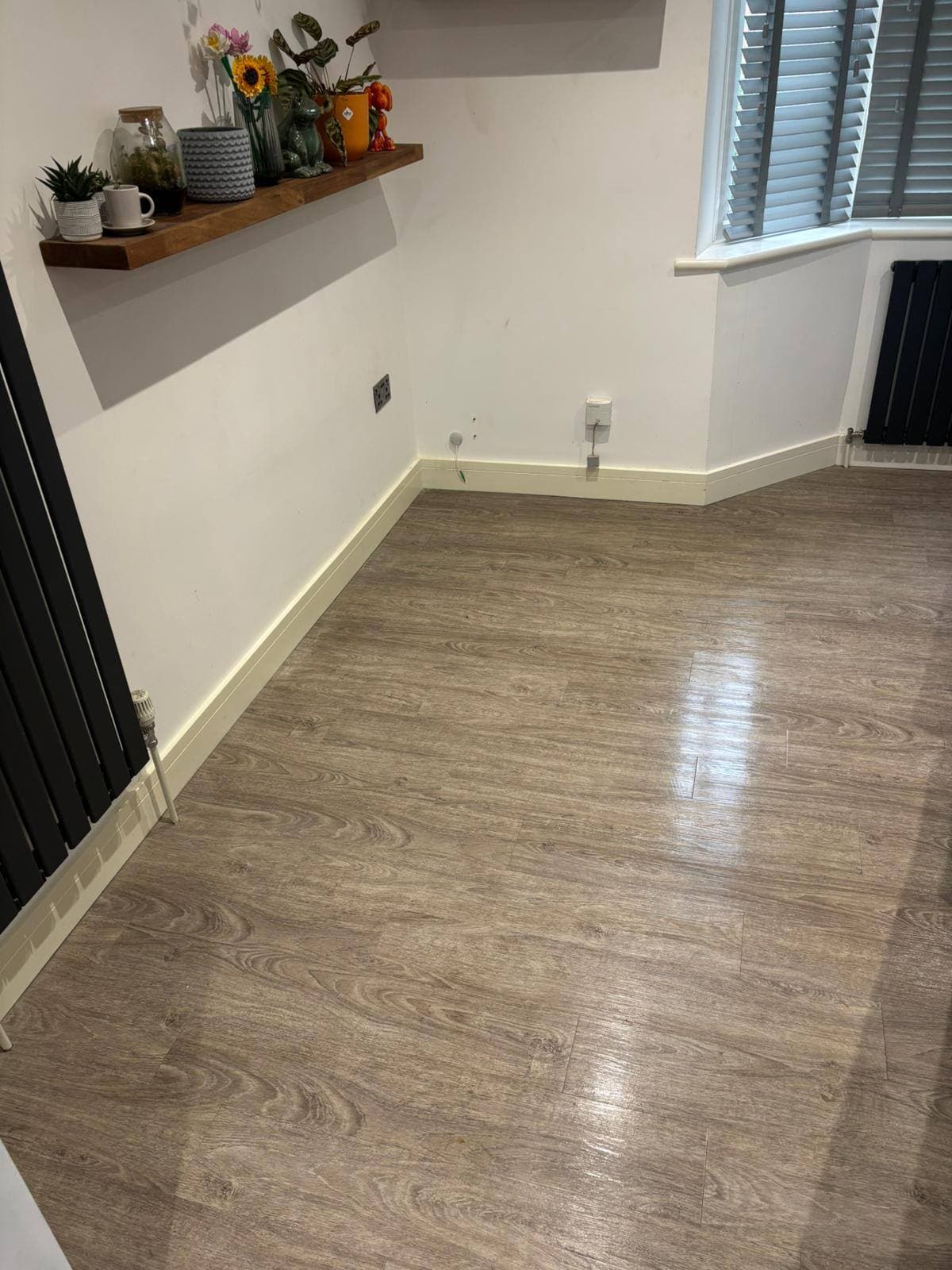 A living room floor swept and mopped to a spotless finish, ready for handover