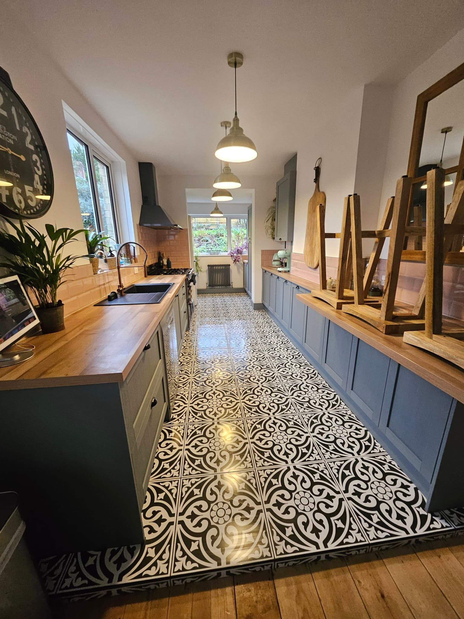 Galley kitchen with patterned tile floor cleaned to a high shine