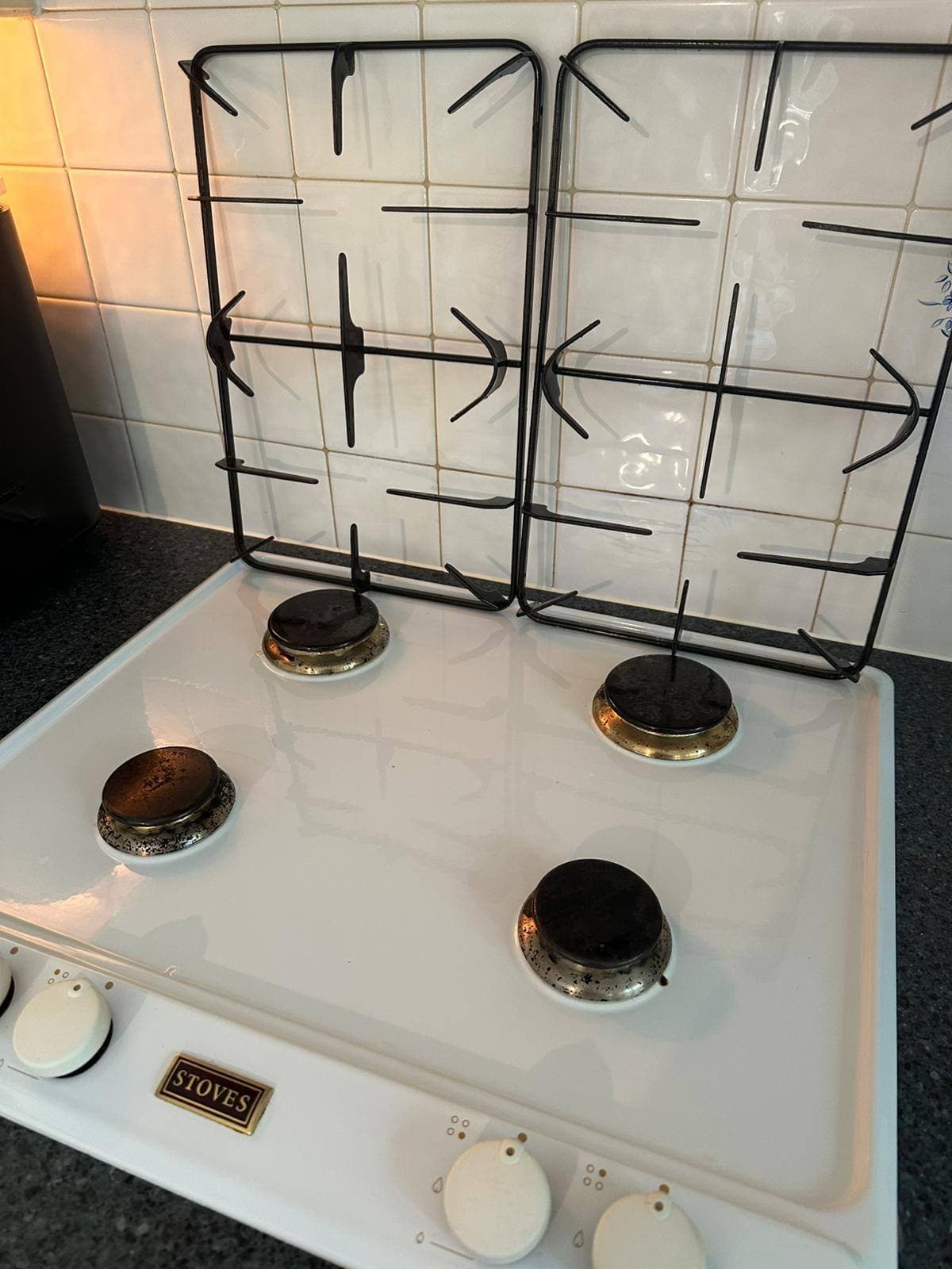 The same gas hob degreased and wiped back to a clean white finish after cleaning